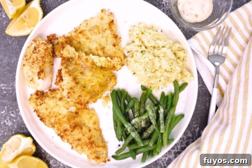 Air Fryer Crispy Parmesan Cod 11 overhead view of air fryer parmesan crusted cod with green beans and couscous