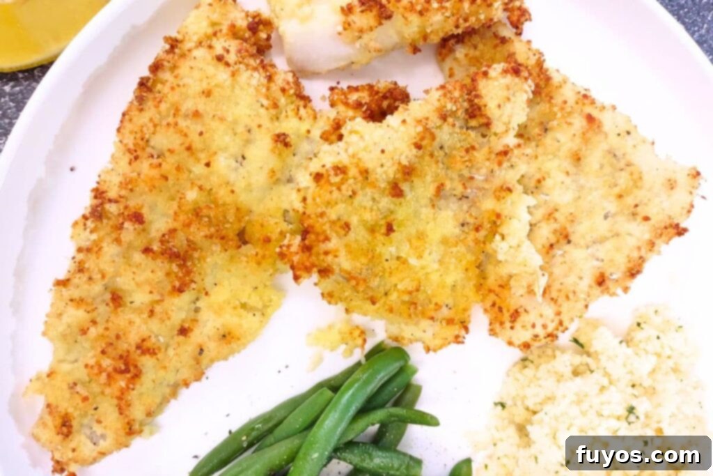 Air Fryer Crispy Parmesan Cod 3 parmesan crusted cod cooked in the air fryer on a plate with vegetables
