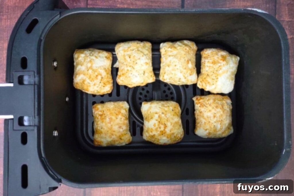 Air Fryer DiGiorno Pizza Bites The Secret to Golden Crispiness 5 Frozen DiGiorno Pizza Bites neatly arranged in a single layer inside an air fryer basket, ready for cooking.