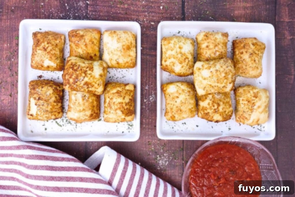 Air Fryer DiGiorno Pizza Bites The Secret to Golden Crispiness 6 Overhead view of several golden-brown DiGiorno Pizza Bites stacked on square plates, served hot and ready.