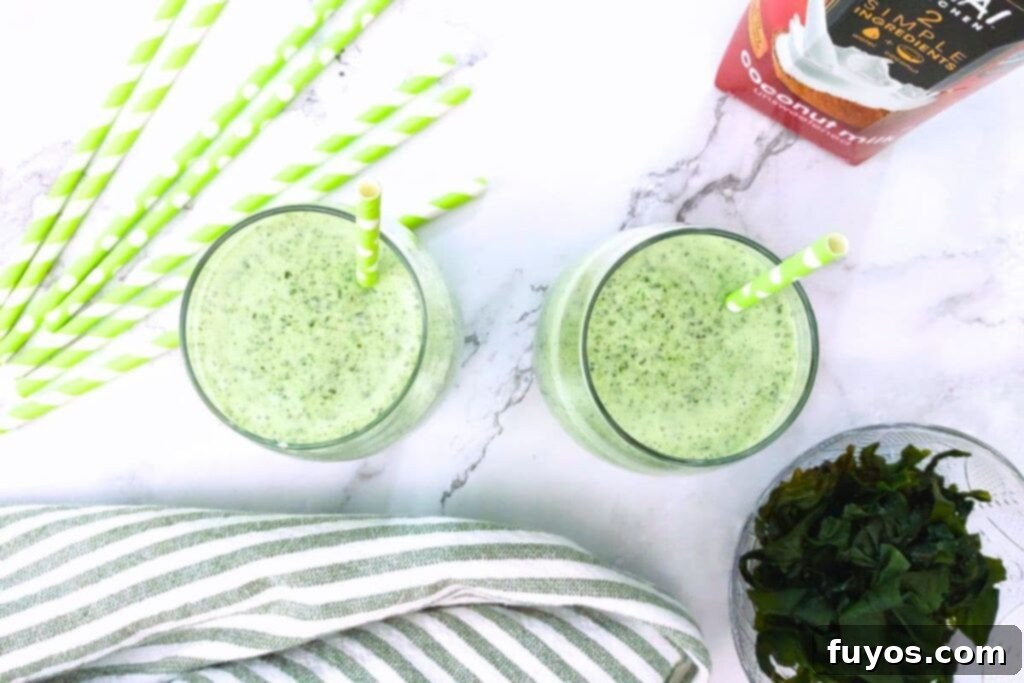 two glasses of seaweed smoothie with straws and fresh seaweed garnish