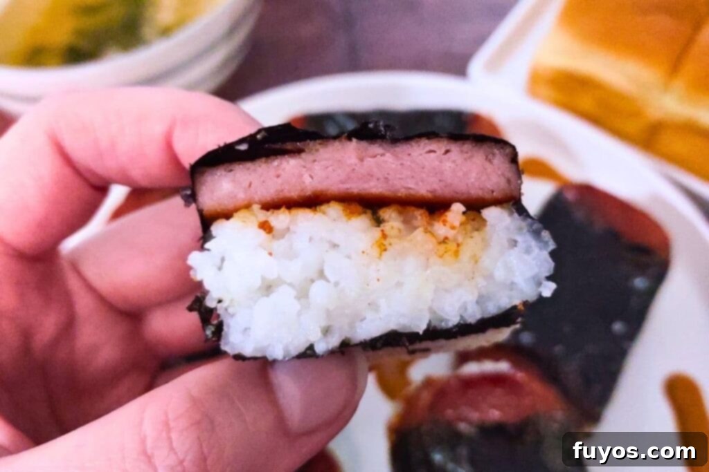 Air Fryer Spam Musubi Your Homegrown Hawaiian Treat 3 holding up air fryer spam musubi cut in half