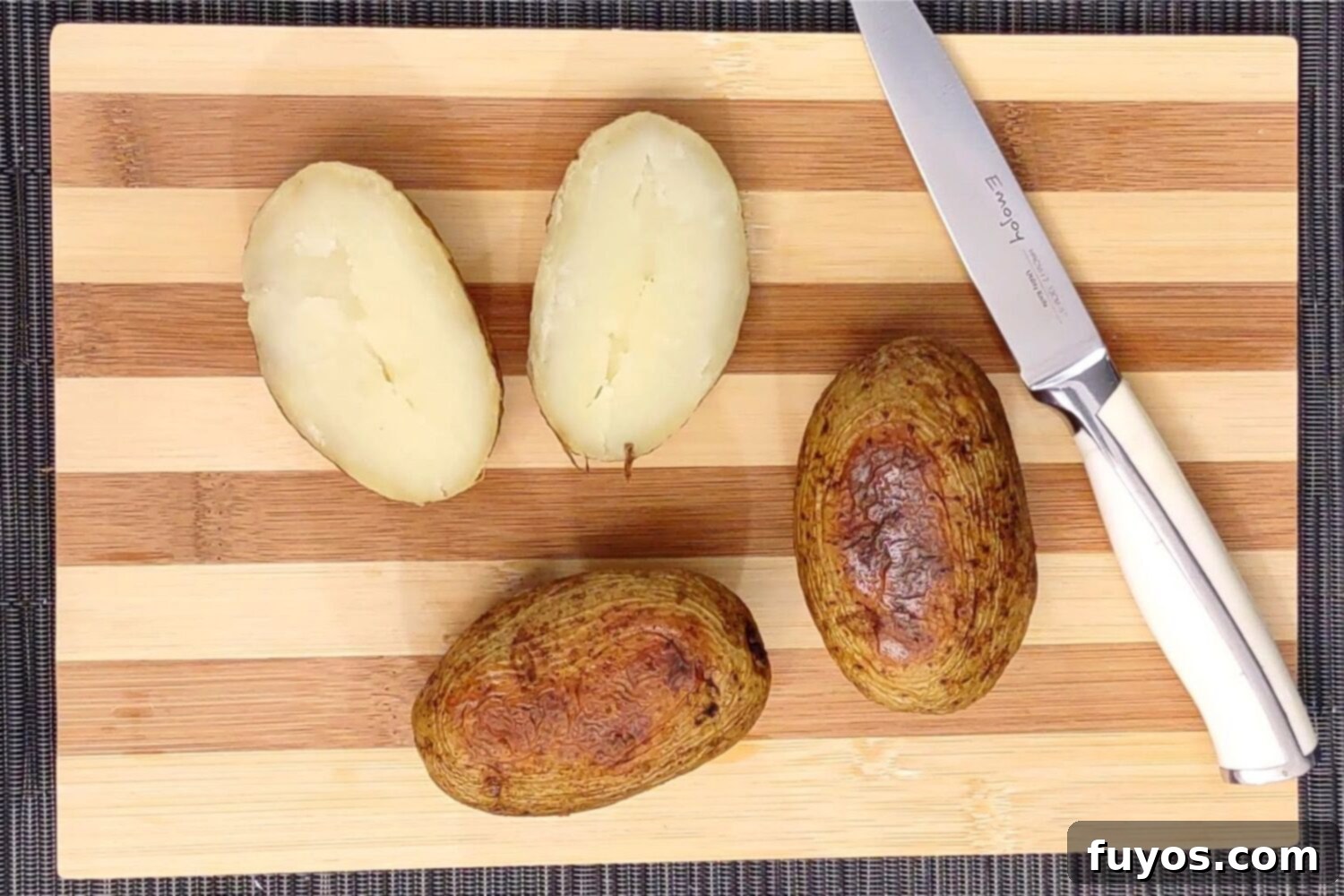 The Best Air Fryer Potato Skins 4 Slicing baked potatoes lengthwise to prepare for scooping