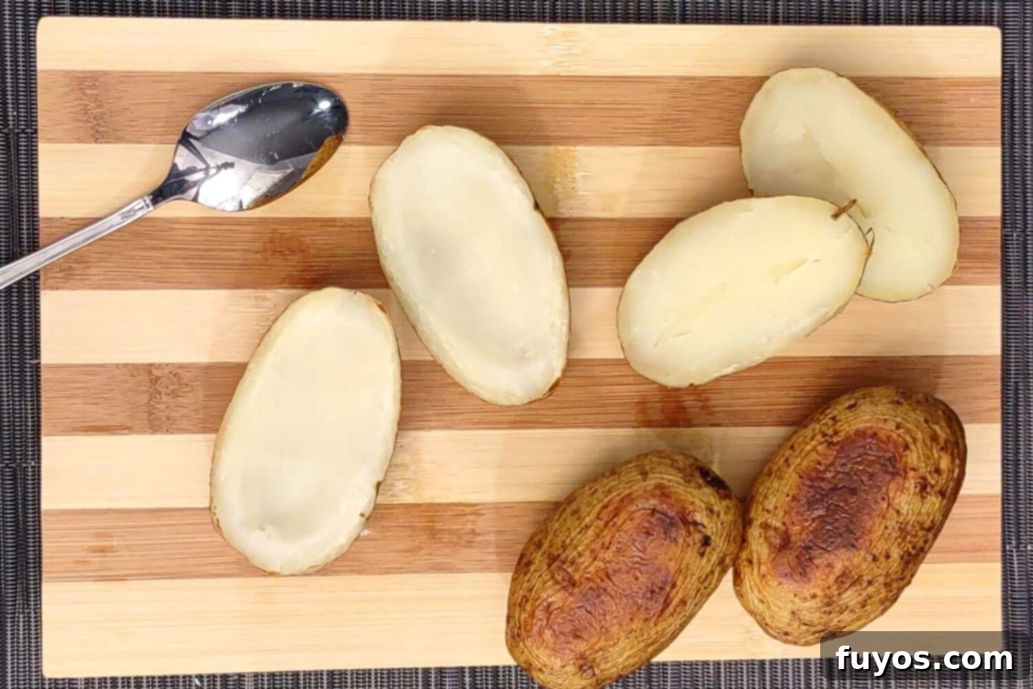 The Best Air Fryer Potato Skins 5 Scooping out the soft potato flesh from baked potato halves