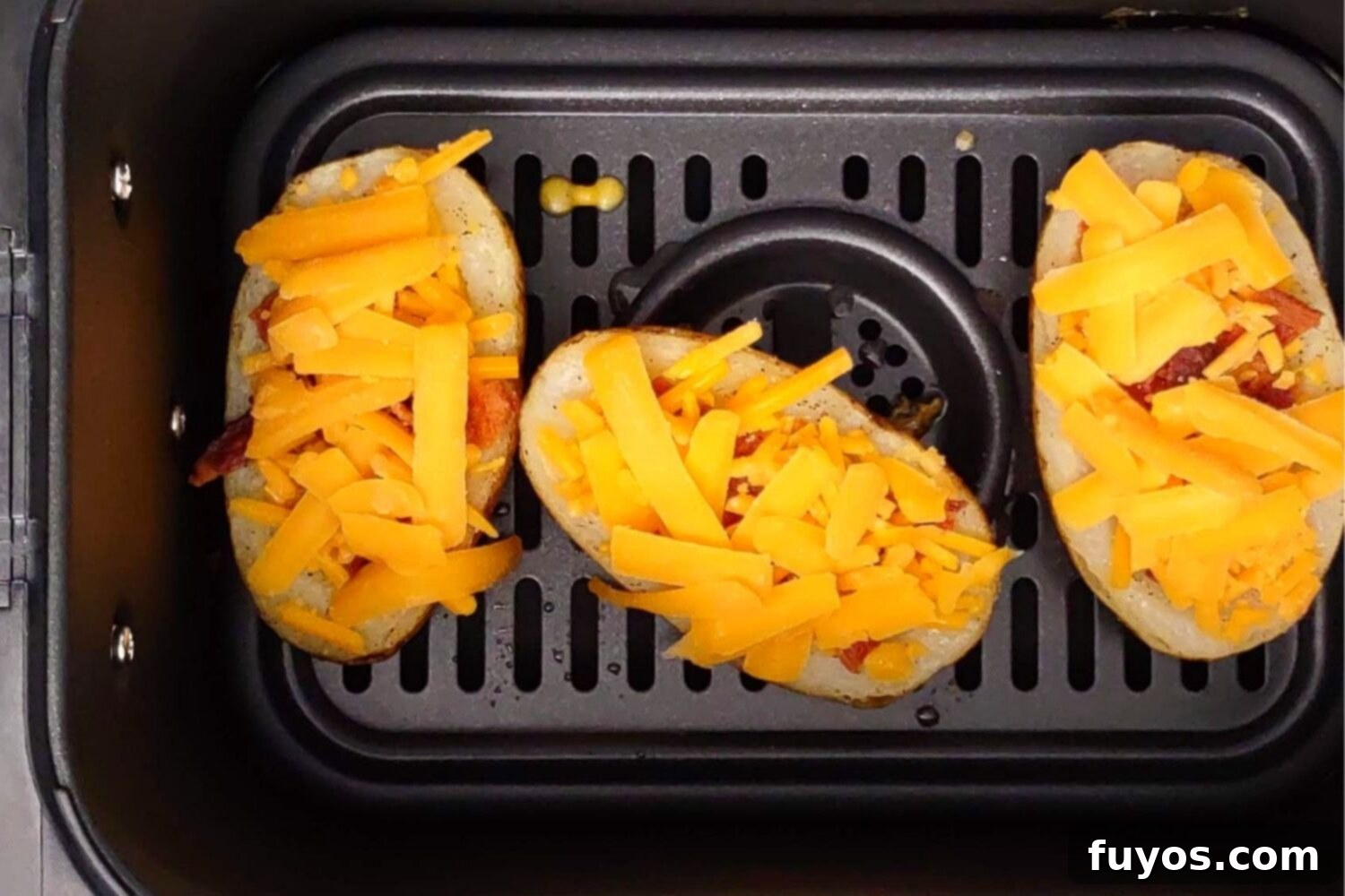 The Best Air Fryer Potato Skins 8 Placing loaded potato skins into the air fryer basket for cooking
