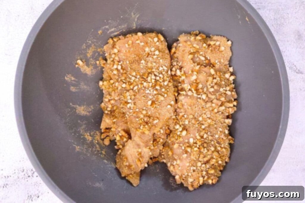 mix coated chicken in broken pretzel pieces