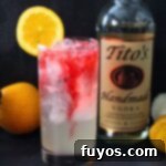 A festive Headless Horseman cocktail for Halloween, garnished with an orange slice and set against a moody background.