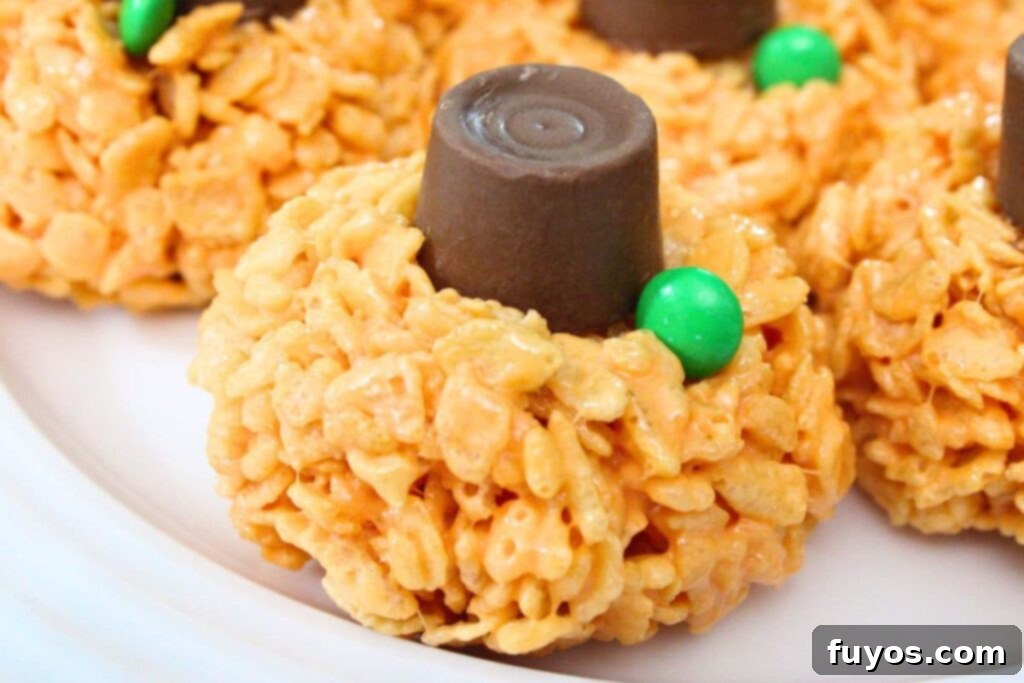 closeup of halloween pumpkin rice krispie treat with a rolo on top