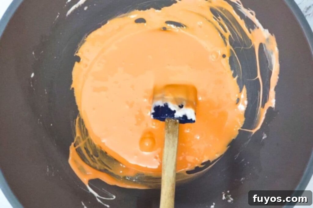 mix food coloring to turn the melted marshmallows orange