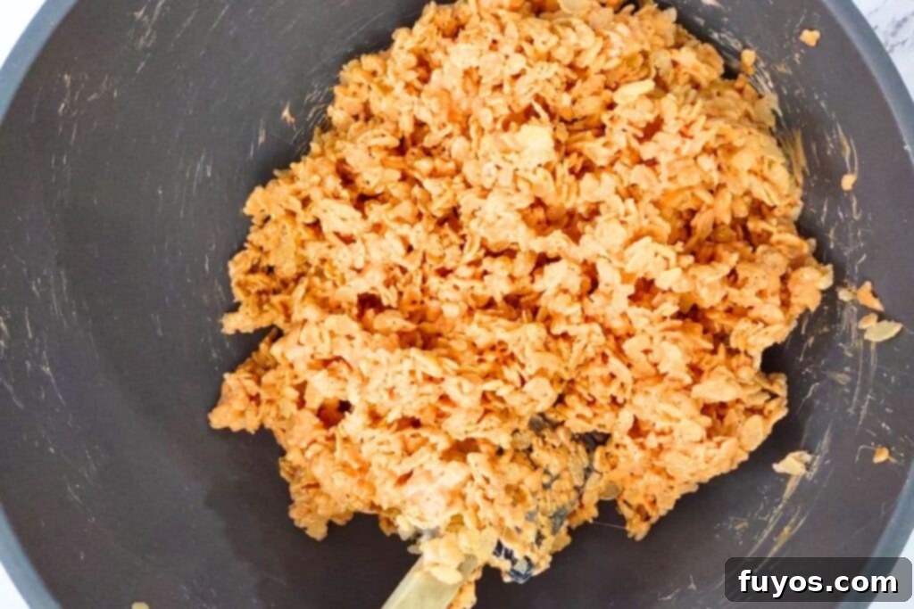 add the rice krispie treats to the orange marshmallow mixture