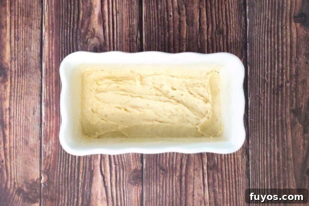 Delicious Homemade Air Fryer Coffee Cake for Breakfast 6 First half of coffee cake batter spread evenly into the bottom of the cake pan.