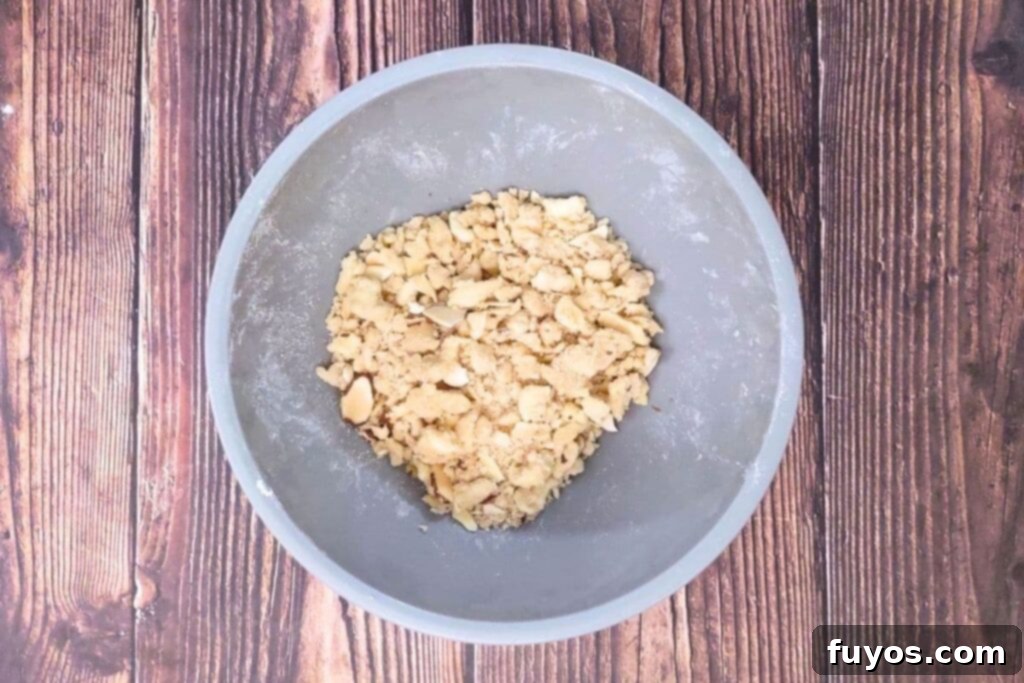 Delicious Homemade Air Fryer Coffee Cake for Breakfast 9 Crumble mixture made from brown sugar, flour, cold butter, and sliced almonds in a small bowl.