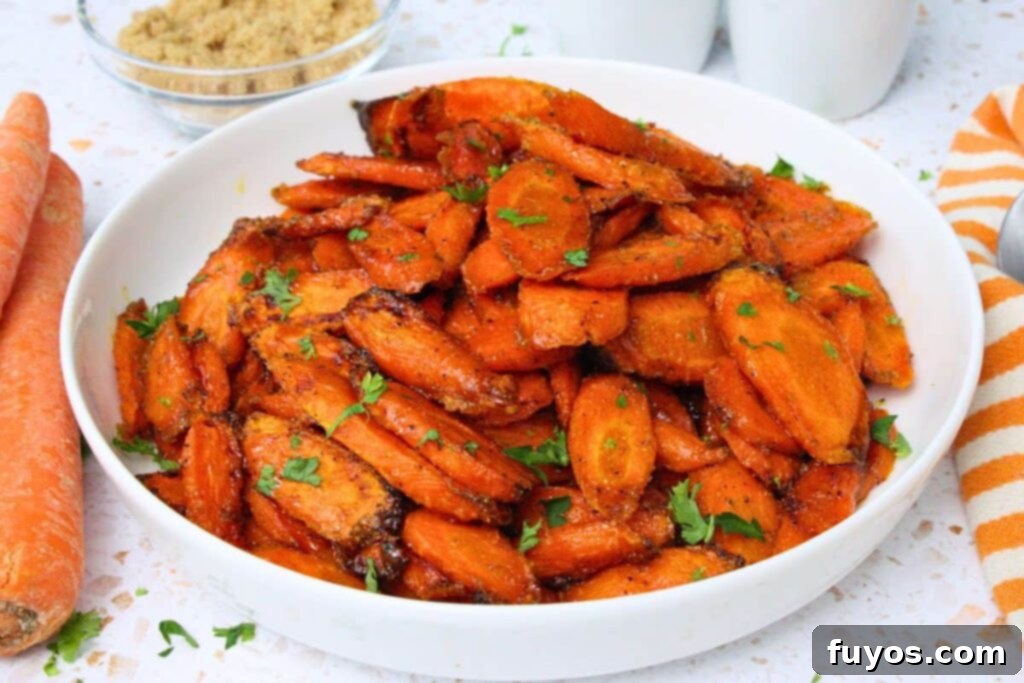 Delicious Air Fryer Brown Sugar Carrots Done in Ten Minutes 9 air fryer brown sugar carrots in a white bowl with fresh parsley garnish