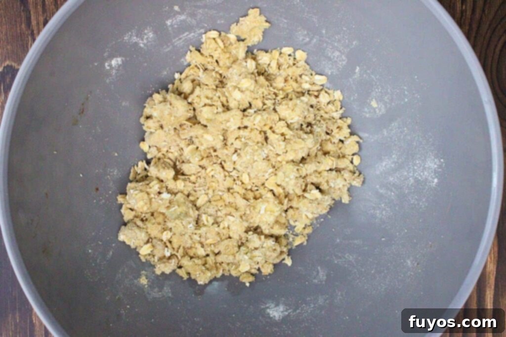 20-Minute Air Fryer Pear Crisp for Fall 6 combine oats with flour, brown sugar, and cubed butter in a bowl