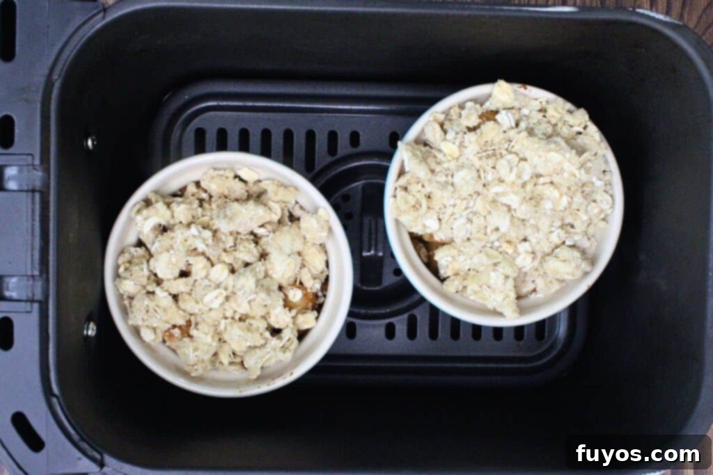 20-Minute Air Fryer Pear Crisp for Fall 7 add streusel over pears and place in air fryer basket
