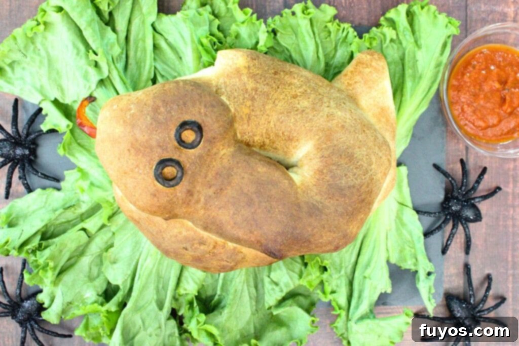 Air Fryer Serpent Bites: Your Halloween Party Hit 15 overhead view of snake calzone made in the air fryer on a bed of lettuce leaves