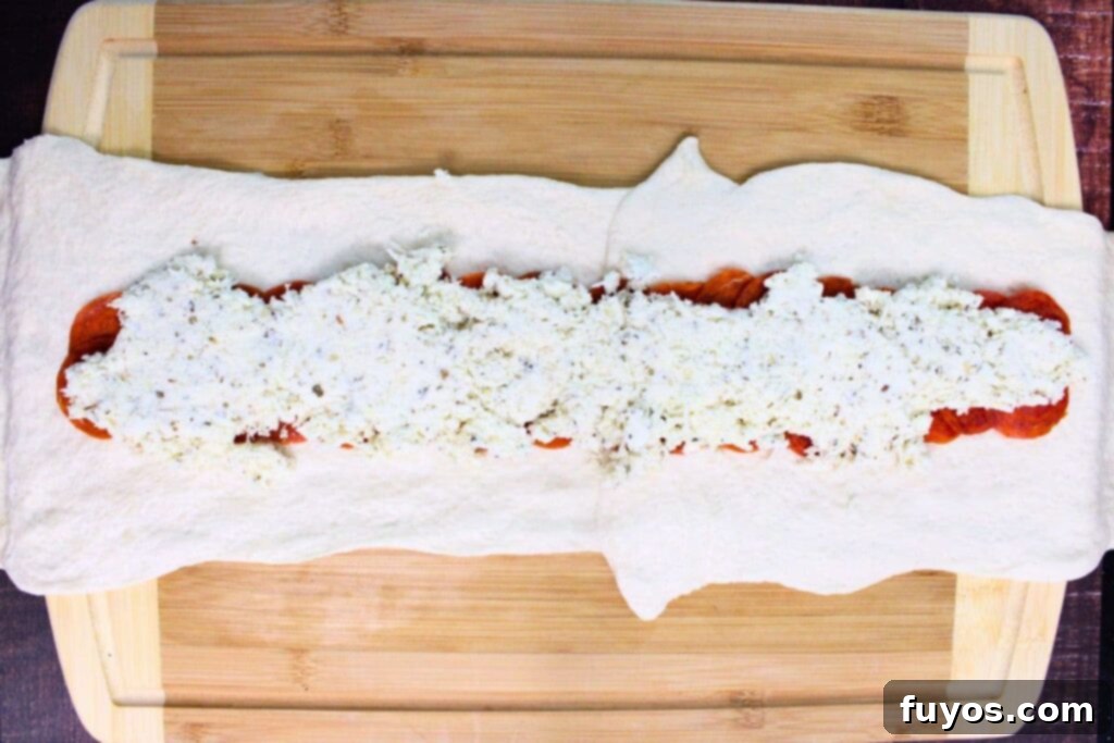 Air Fryer Serpent Bites: Your Halloween Party Hit 8 add pepperoni and cheese filling to the center of the long dough shape