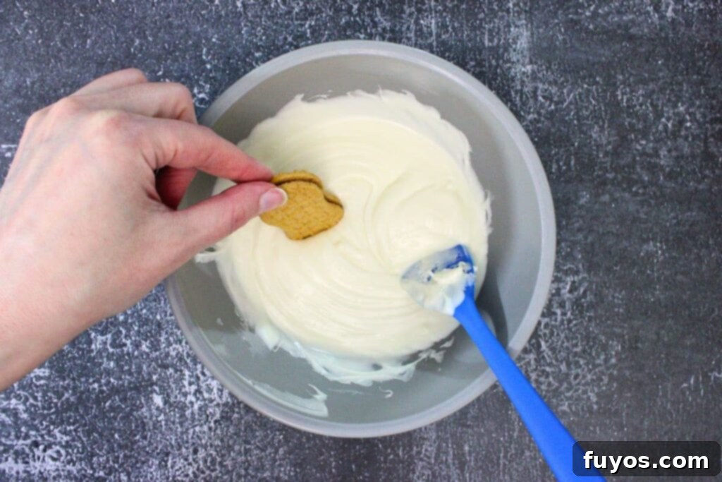 Haunted Nutter Butter Ghosts 3 Ingredient Halloween Magic 7 dip the nutter butter about halfway into the melted chocolate