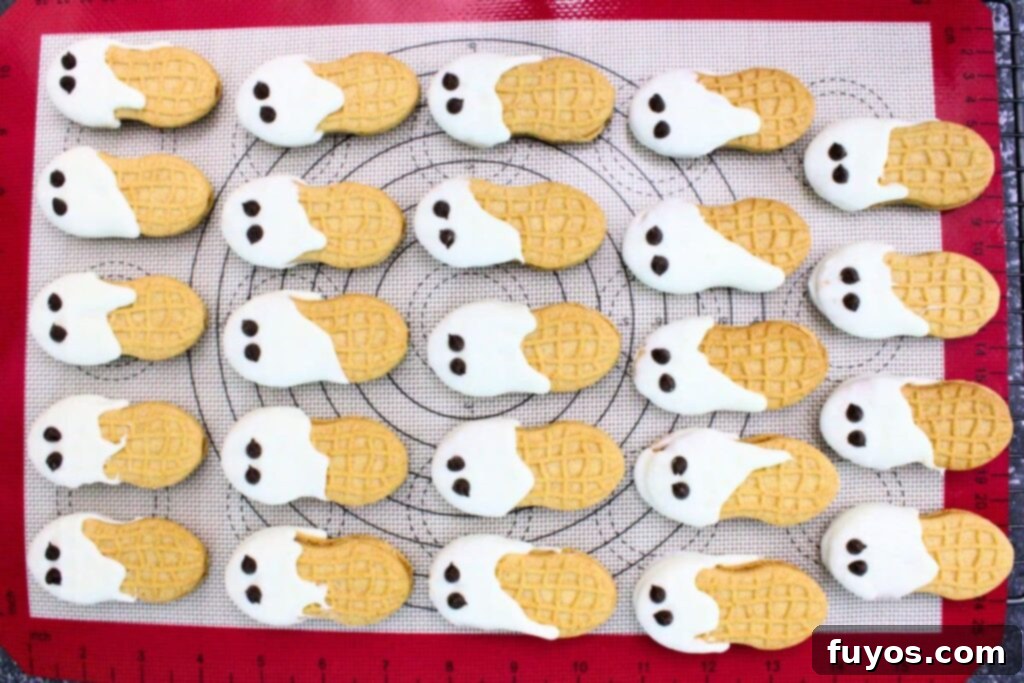 Haunted Nutter Butter Ghosts 3 Ingredient Halloween Magic 9 add chocolate chips for eyes to each of the ghosts