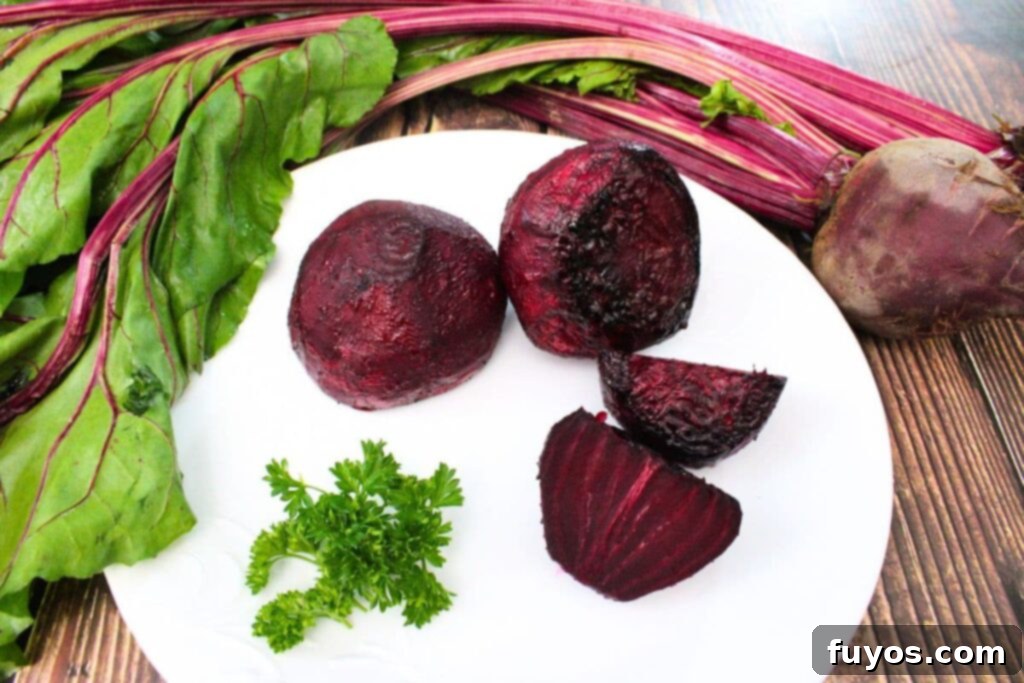 Air Fryer Roasted Whole Beets in Foil 9 delicious air fryer whole roasted beets on a plate with fresh raw beets above