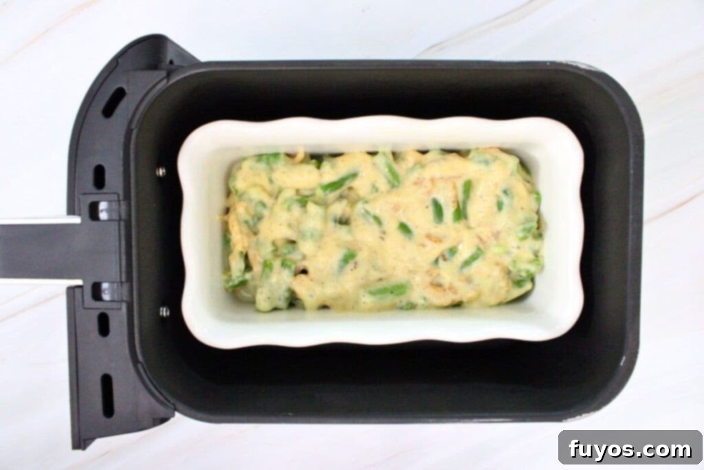 Transferring the green bean mixture to a casserole dish for the air fryer