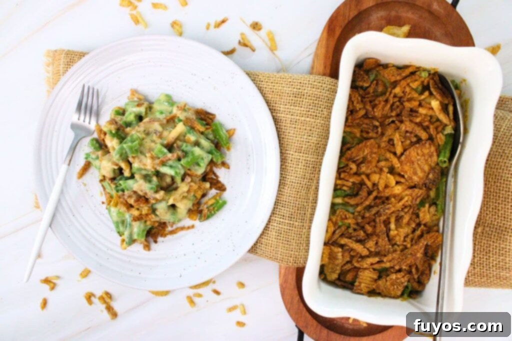 Overhead view of crispy air fryer green bean casserole on a plate next to the baking dish