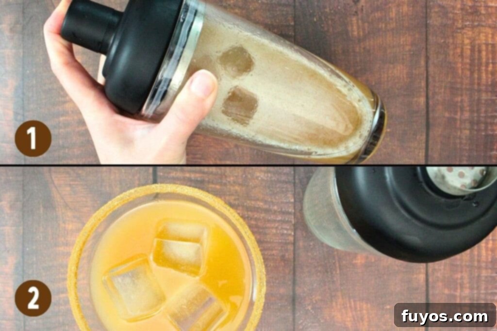 A spiced pear margarita being shaken in a cocktail shaker and then strained into a glass filled with ice.