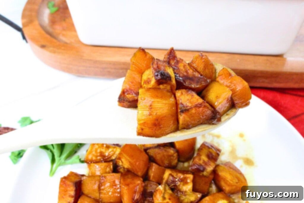 Quick Air Fryer Candied Yams Side 3 holding up a wooden spoonful of air fryer candied yams