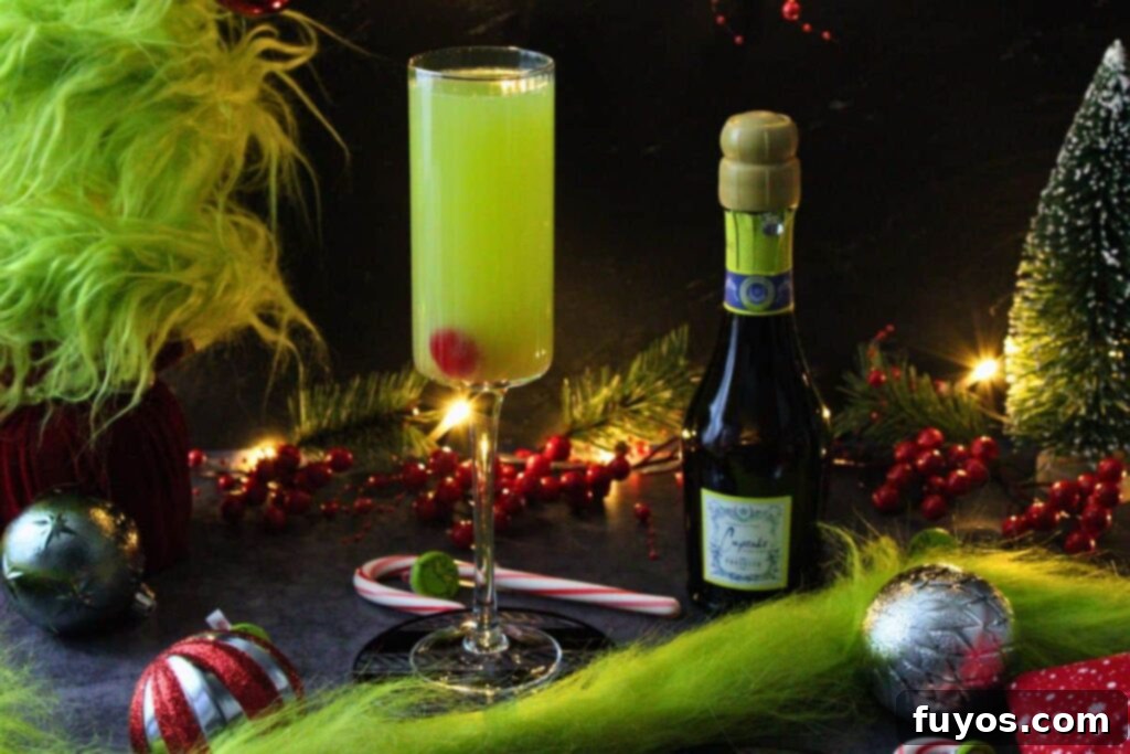 Three Ingredient Grinch Whoville Mimosas 3 festive grinch mimosa in a holiday scene next to mini champagne bottle
