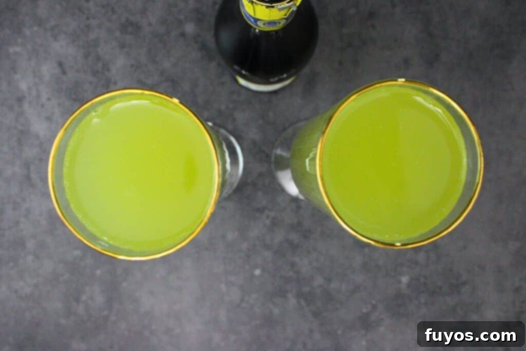 Three Ingredient Grinch Whoville Mimosas 6 pour champagne over grinch mimosa base
