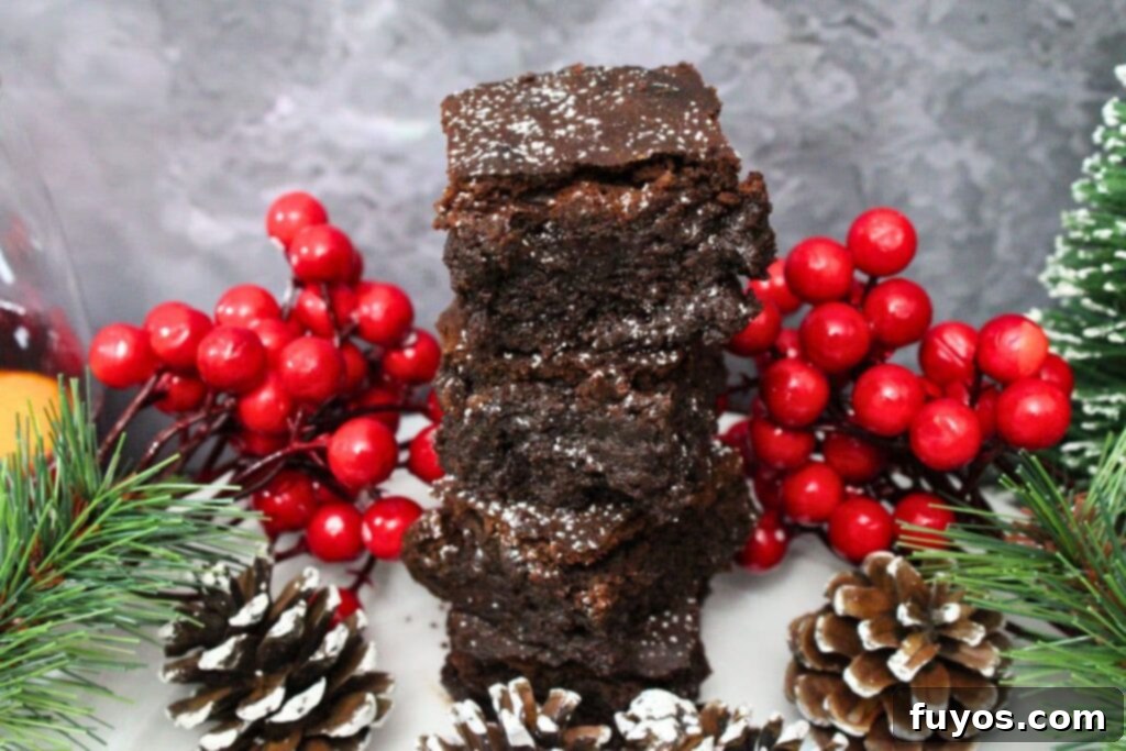 stacked up mulled wine brownies surrounded by winter holiday decorations