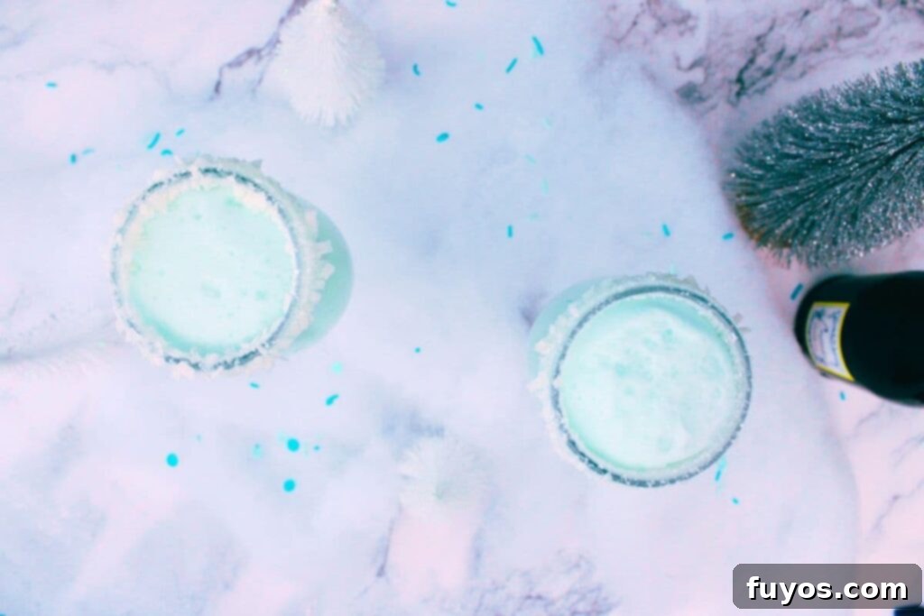 Jack Frost Mimosa Your Sparkling Winter Brunch Delight 9 overhead view of jack frost mimosas surrounded by fake snow