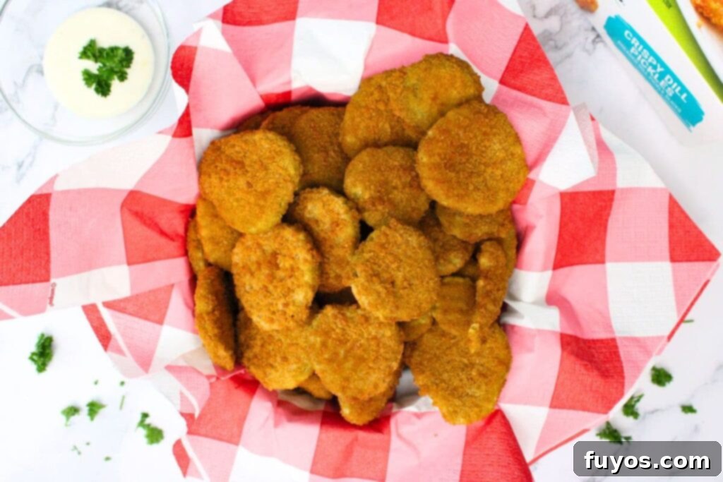 overhead view of air fryer frozen fried pickles in a basket