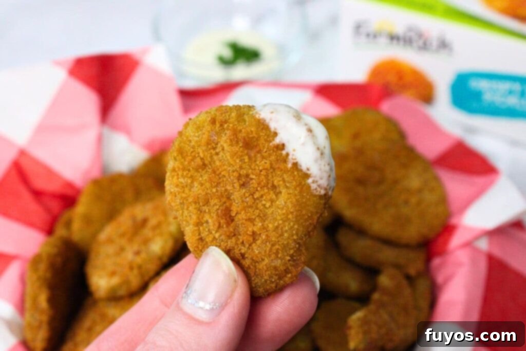 holding up an air fryer fried pickle dipped in ranch