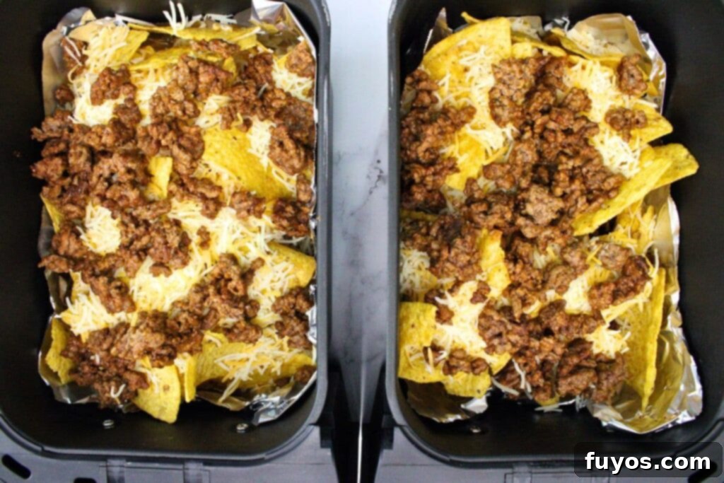 The Ultimate Air Fryer Nachos for Game Day 11 top with another layer of chips, ground beef, and cheese