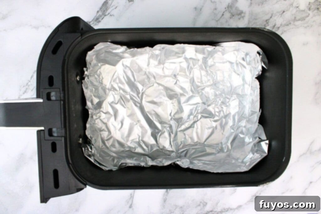 The Ultimate Air Fryer Nachos for Game Day 8 line air fryer basket with foil to create a bowl