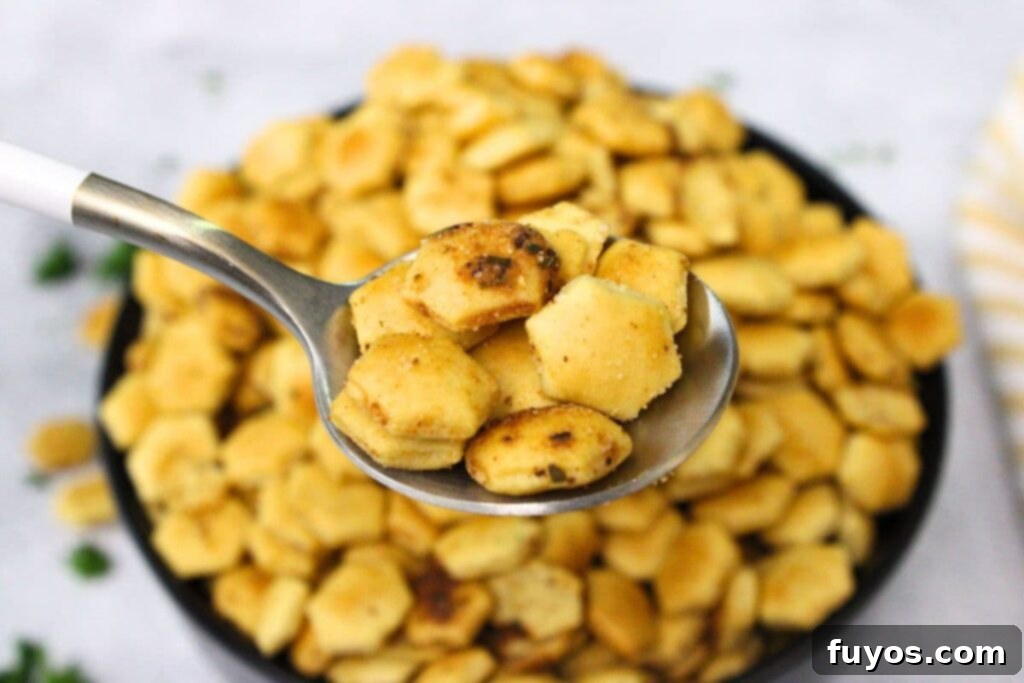 holding up air fryer oyster crackers on a spoon