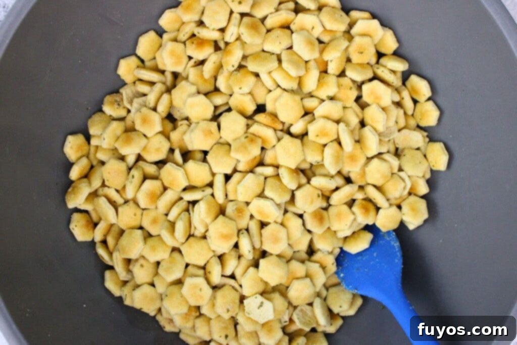 in a large mixing bowl combine oyster crackers with oil and seasoning mix