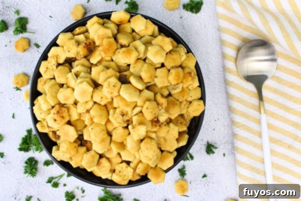 overhead view of air fryer oyster crackers in a bowl with a spoon to the side