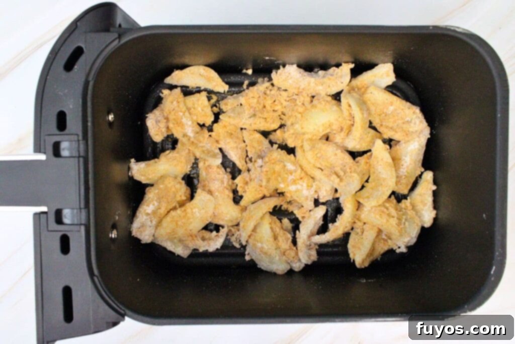 add onions to air fryer basket and spray with nonstick oil
