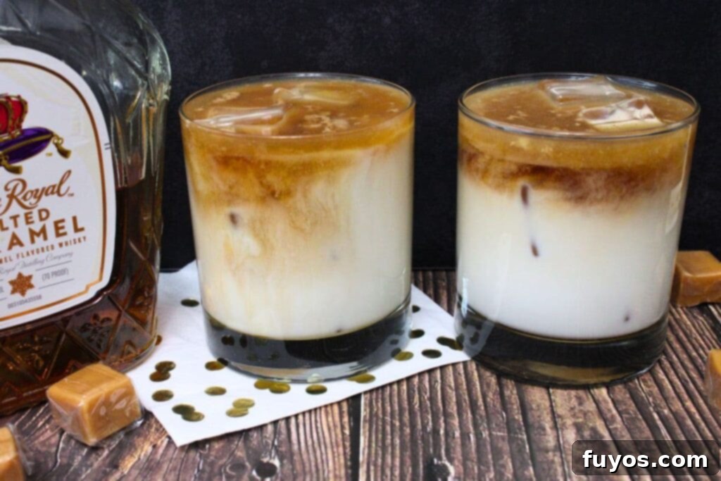 Salted Caramel Royal White Russian Bliss 3 Two beautifully prepared Crown Royal Salted Caramel White Russian drinks, garnished with a dusting of cocoa, against a elegant dark background, emphasizing their festive appeal.