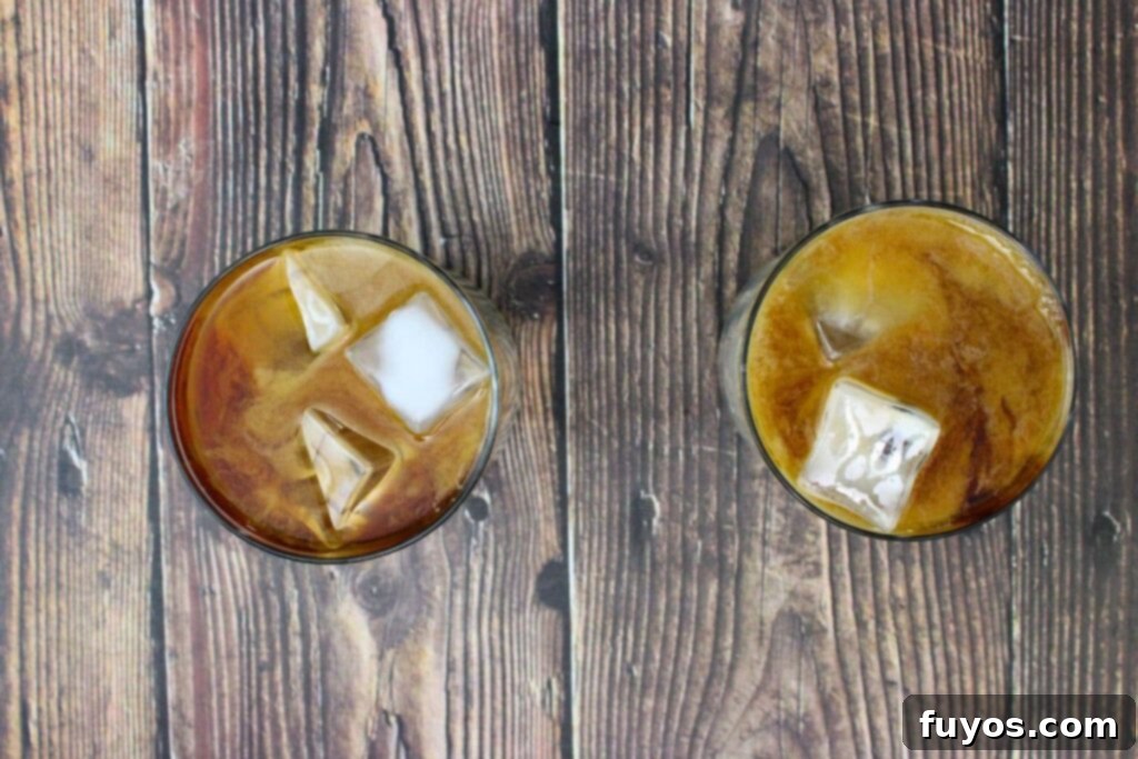 Salted Caramel Royal White Russian Bliss 6 The second step: Ice cubes are added to the glass, followed by a pour of half and half, creating a delightful creamy layer over the mixed spirits.