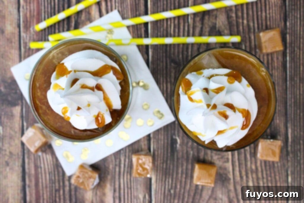 Salted Caramel Royal White Russian Bliss 7 An overhead view of two finished Crown Royal Salted Caramel White Russian drinks, garnished with whipped cream and caramel drizzle, ready for serving.