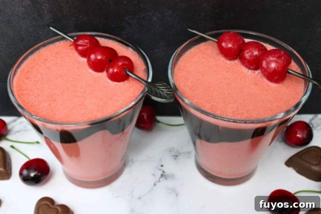 Indulge This Valentine's: Chocolate Covered Cherry Martini 9 two glasses filled with chocolate covered cherry martinis and cocktail cherries
