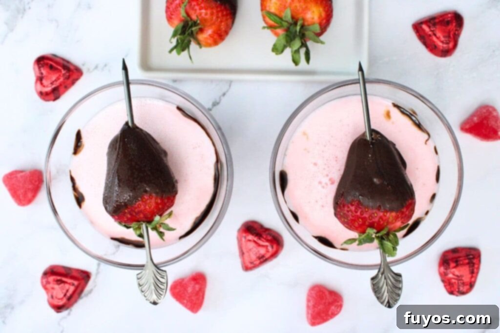 overhead view of two chocolate covered strawberry martini cocktails with strawberry skewers on top