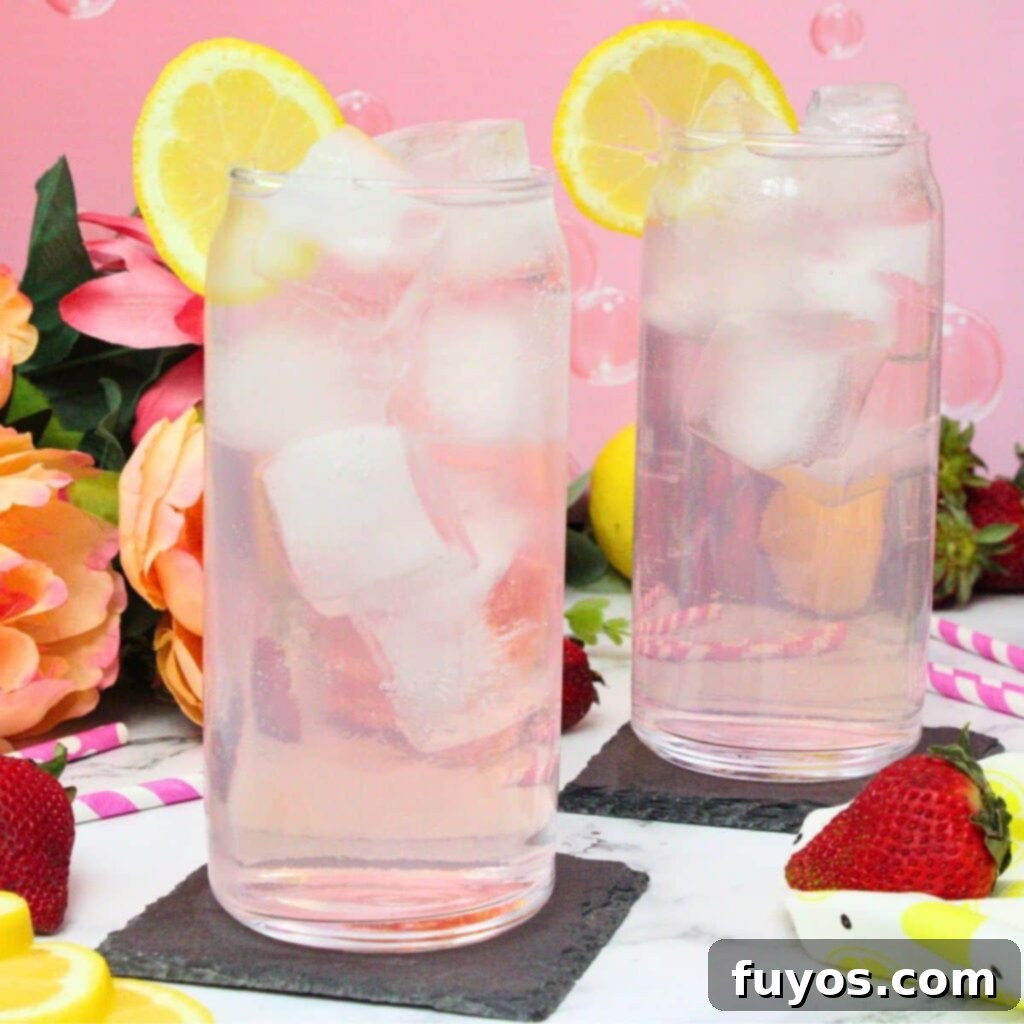 Pink Whitney and Sprite Recipe Easy 2 Ingredient Cocktail 2 A vibrant pink Whitney and Sprite cocktail in a glass, garnished with a lemon slice, perfect for a refreshing drink.