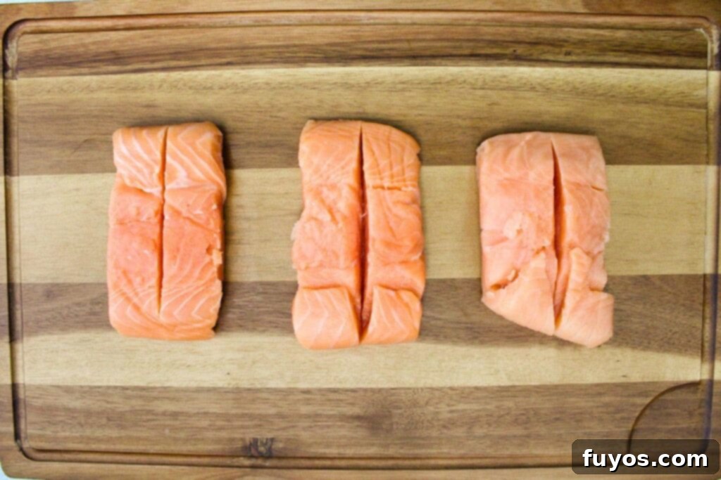 Patting salmon dry and making a vertical slice in the top of the fillet to create a pocket for stuffing