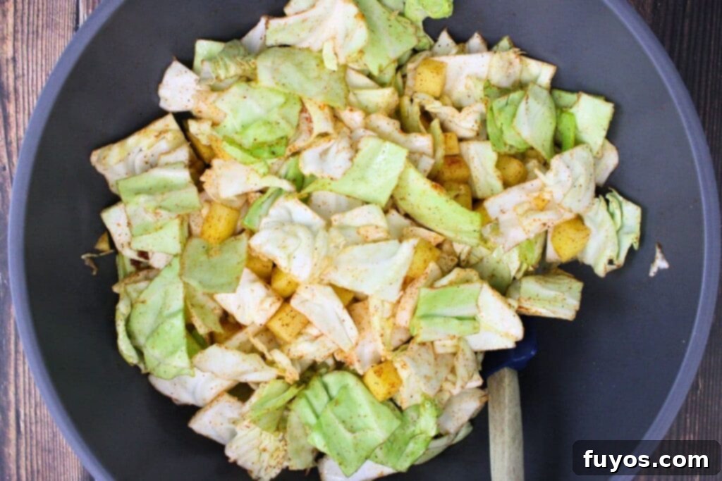 Simple Air Fryer Cabbage and Potatoes 6 combine potatoes, cabbage, olive oil, and seasonings in a bowl