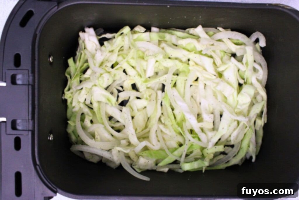 Easy 15-Minute Air Fryer Cabbage and Onions 7 place cabbage and onions mixture in air fryer basket