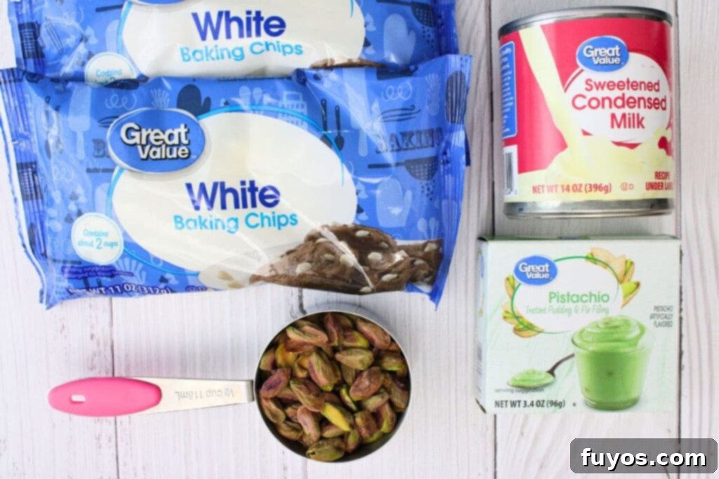 4 Ingredient Microwave Pistachio Fudge Delight 4 ingredients laid out for microwave pistachio fudge: white chocolate chips, sweetened condensed milk, pistachio pudding mix, and shelled pistachios